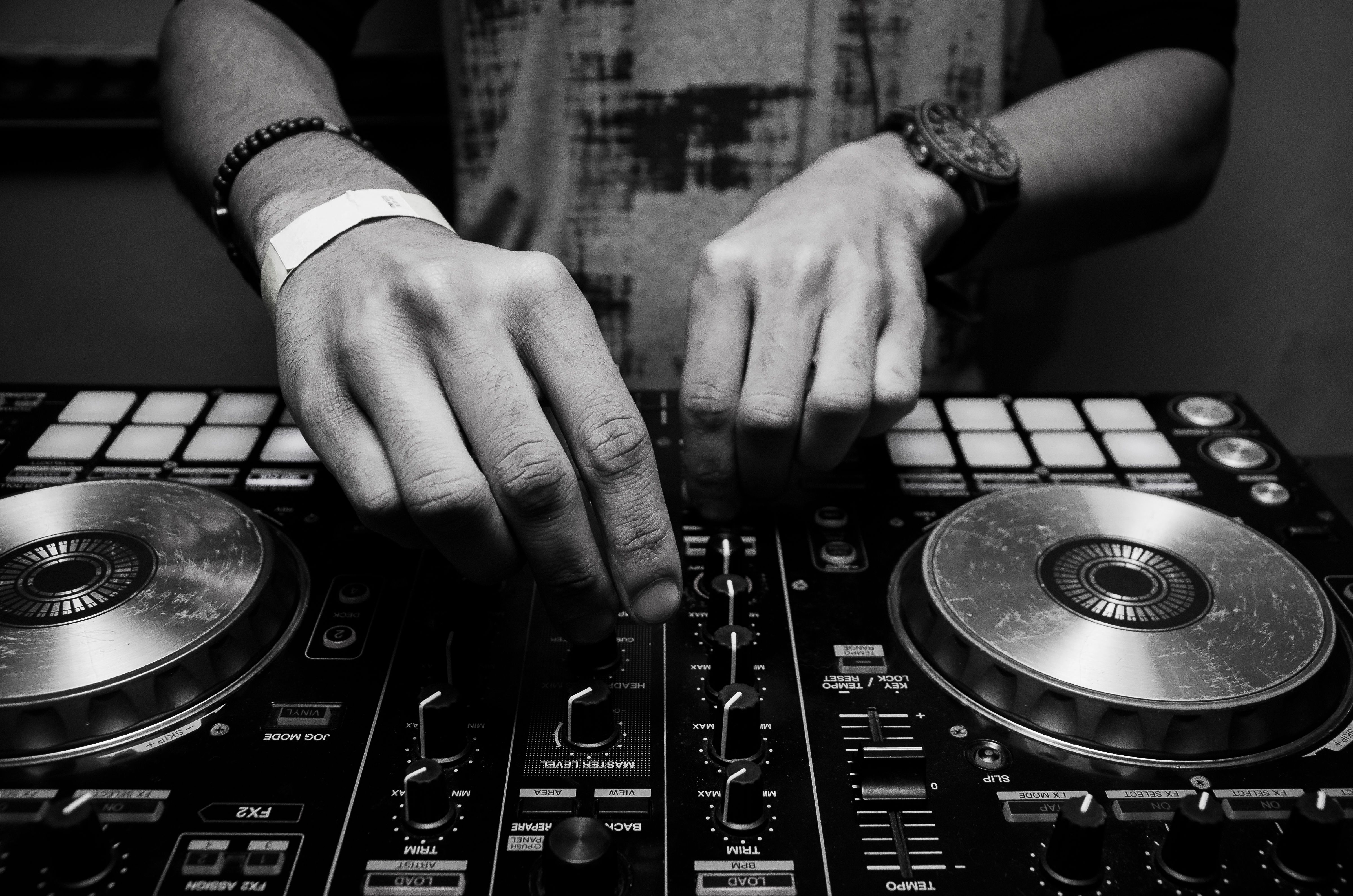 DJ mixing console with moody lighting at Auburn event
