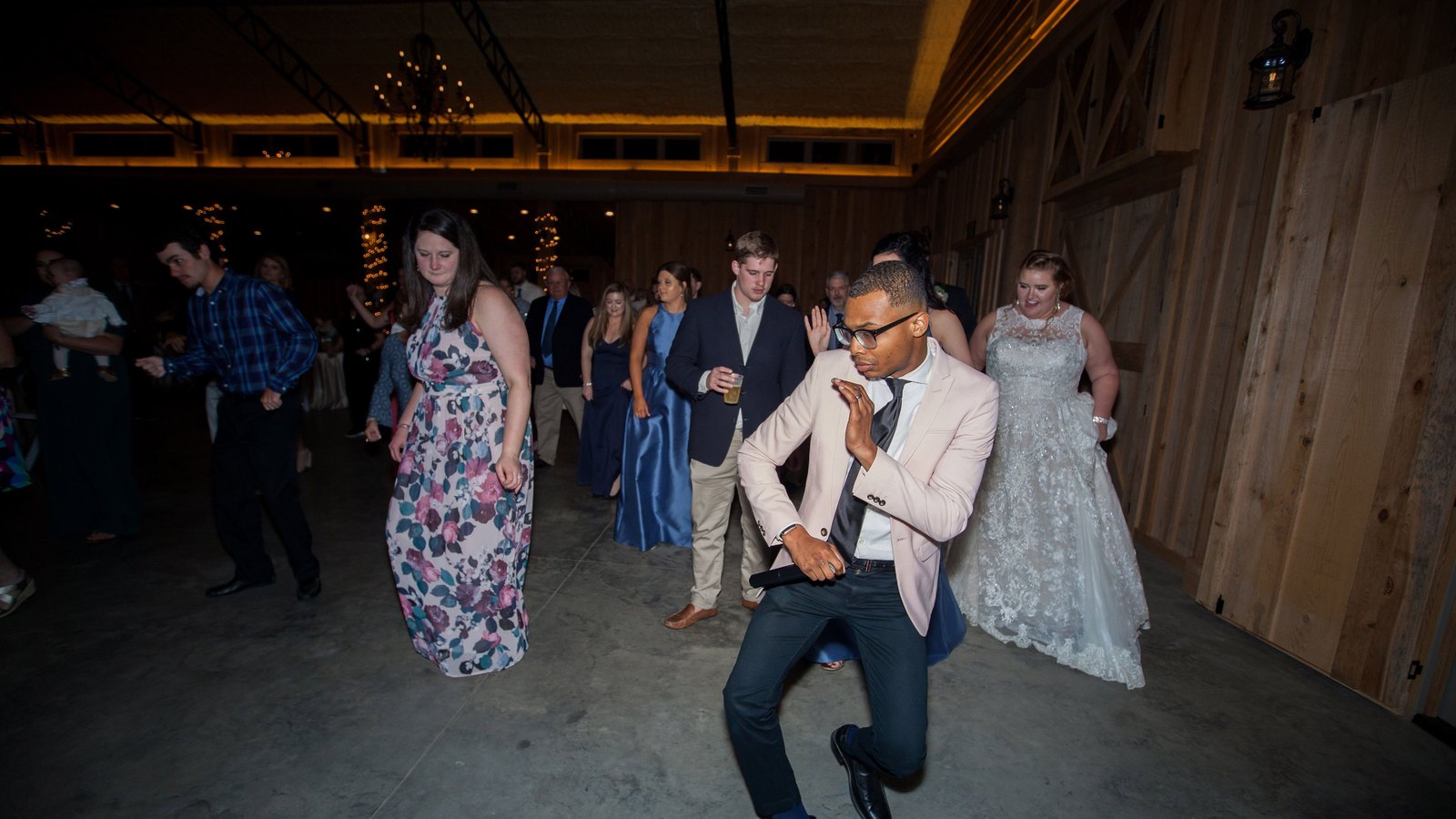 Auburn DJ dancing with the bride and guests on the floor at a Southern barn wedding reception